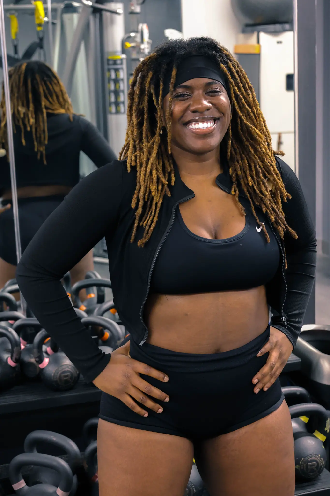 Sammar, personal trainer, smiling in her gym